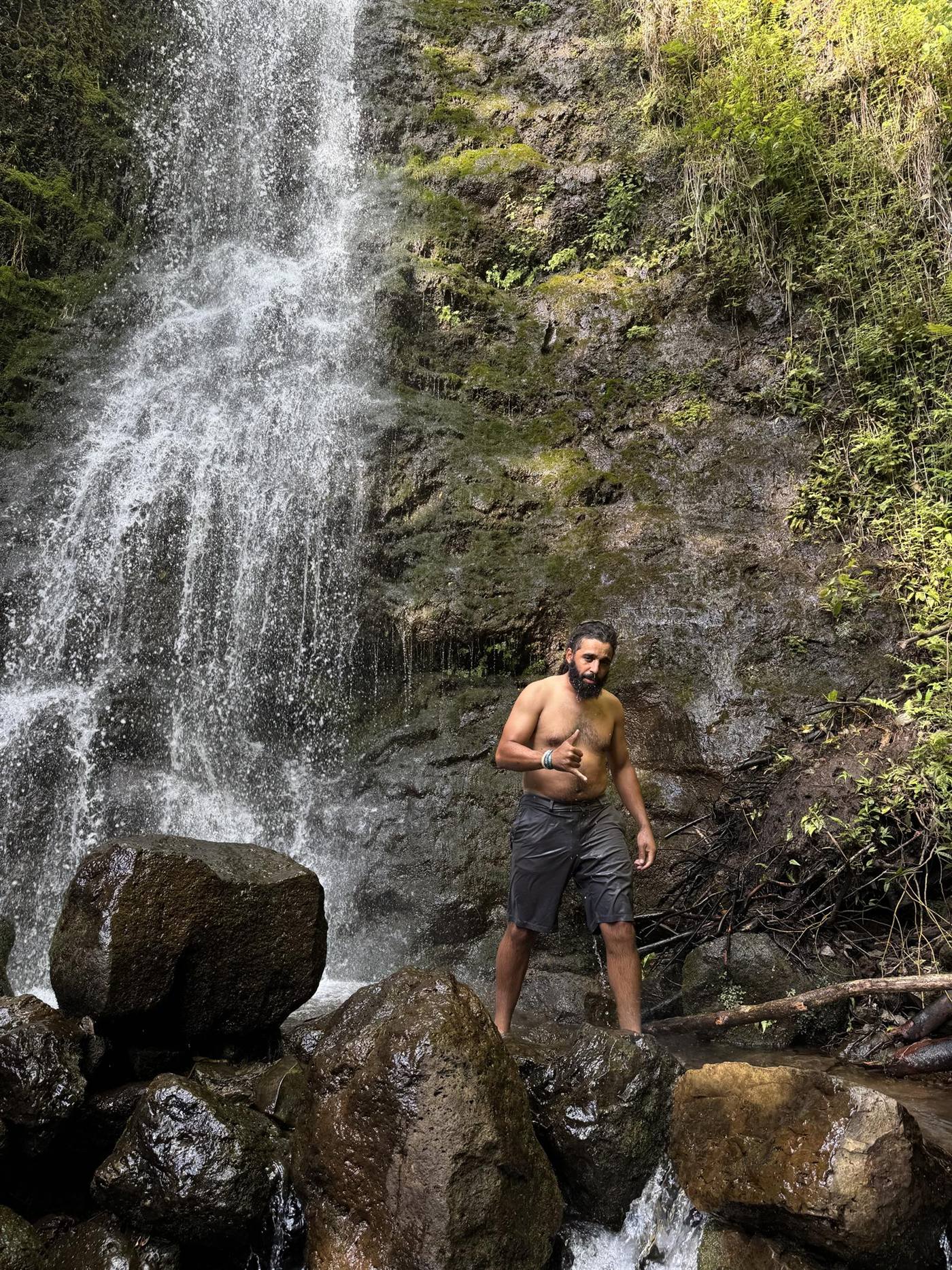 A guest in front of a waterfall.