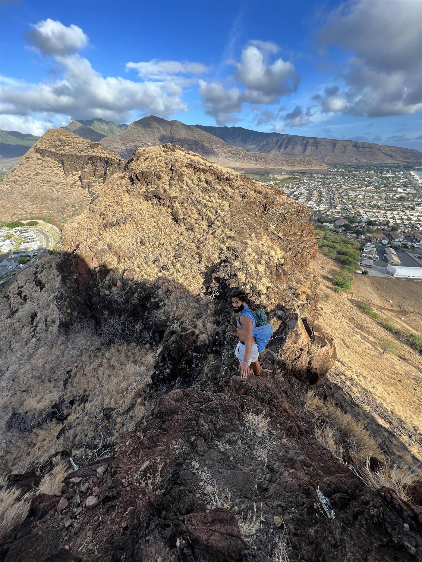 Scrambling the red rock above the coast.